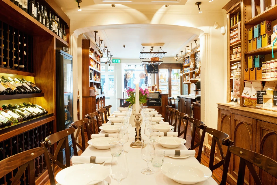 Private dining room at Café Murano prepared for a seated dinner