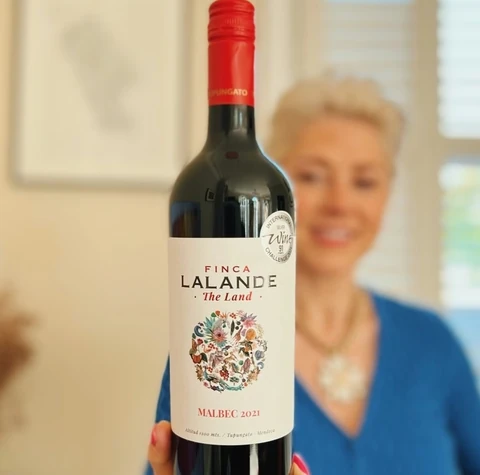 Finca LaLande Malbec 2021 bottle held in front of a blurred woman