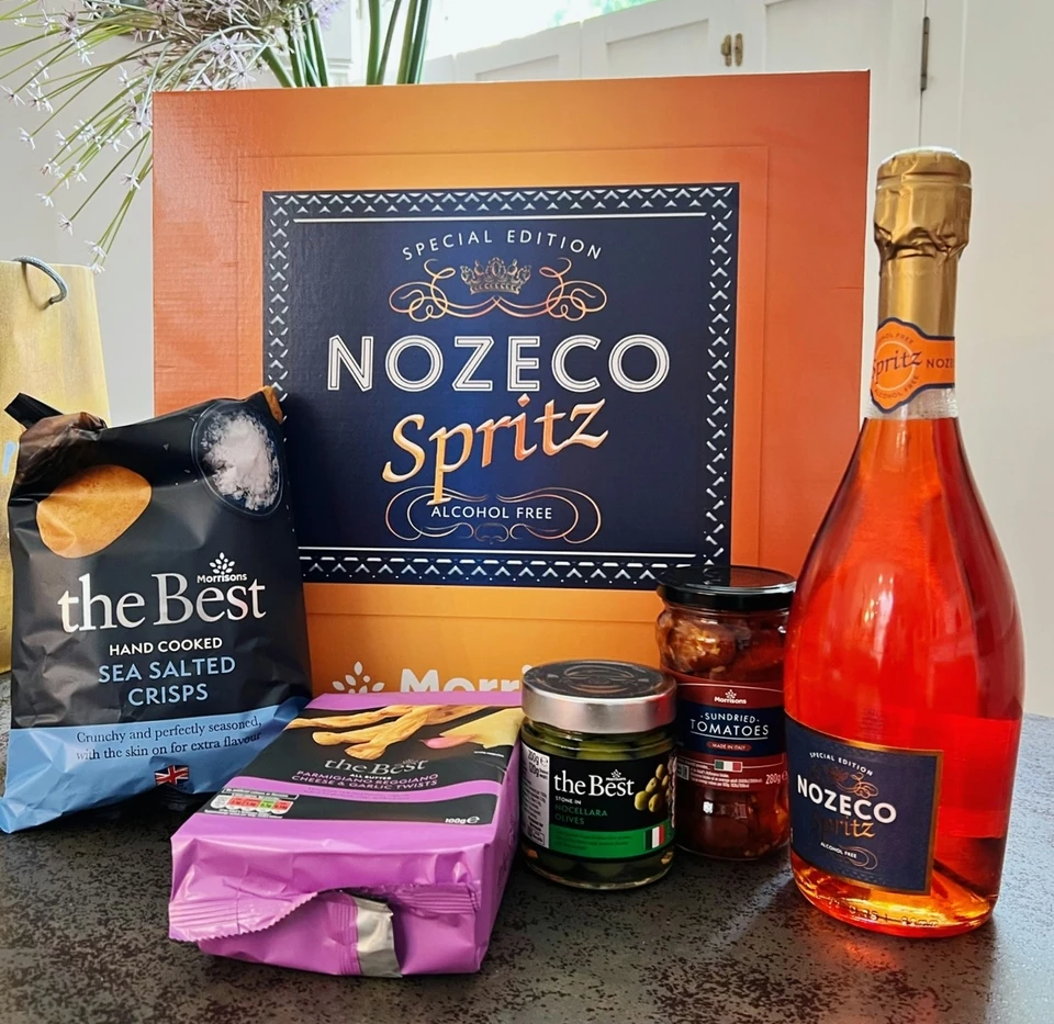 Nozeco Spritz bottle with Morrisons crisps, breadsticks, olives and sundried tomatoes