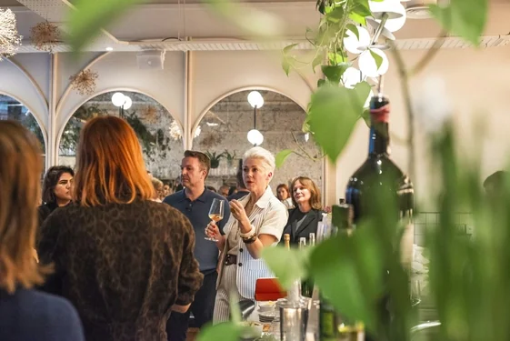 Guests take part in a wine tasting at a table