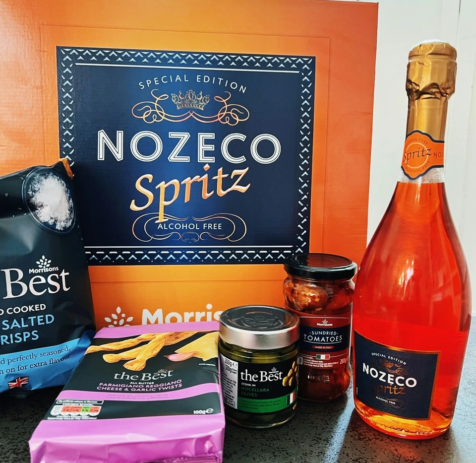 Morrisons Nozeco Spritz alcohol-free bottle with savoury snacks and a branded gift box