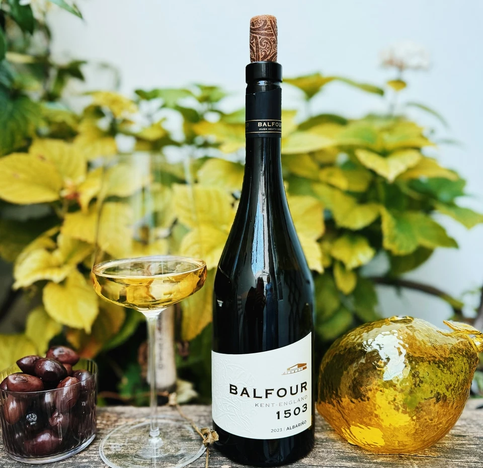 Balfour 1503 Albariño bottle beside a filled coupe, olives and a gold ornament