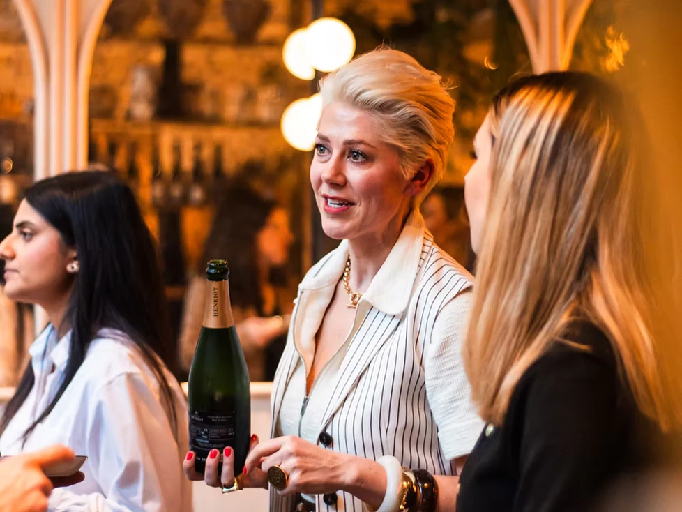 Elizabeth pouring wine for guests at a women-in-wine networking event